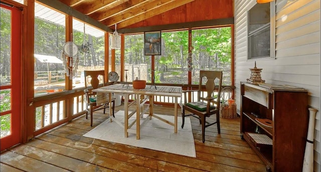 sunroom / solarium with vaulted ceiling with beams, wooden ceiling, and a healthy amount of sunlight