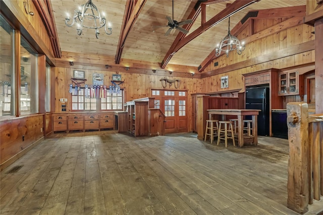 interior space featuring wood ceiling, beamed ceiling, and wooden walls