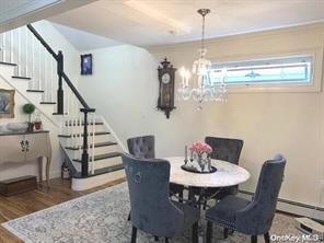 dining area featuring hardwood / wood-style floors and a notable chandelier