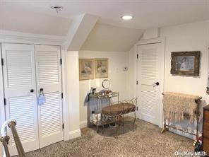 interior space with a closet, vaulted ceiling, and carpet flooring