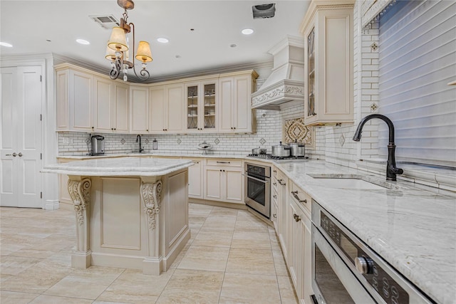 kitchen featuring backsplash, premium range hood, sink, hanging light fixtures, and stainless steel appliances