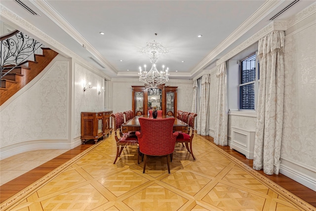 dining space featuring parquet flooring, ornamental molding, and an inviting chandelier