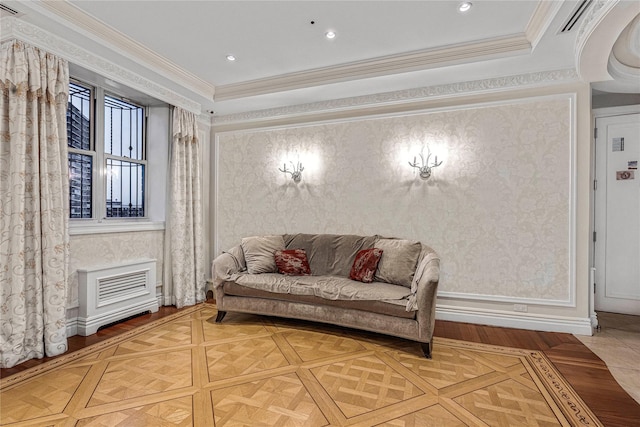 living area with crown molding and parquet flooring