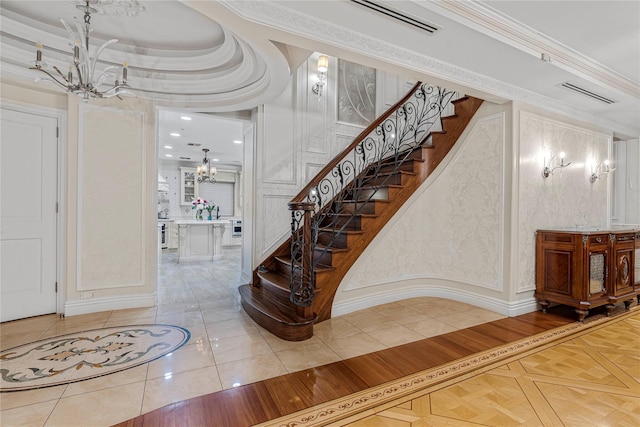 foyer entrance with tile patterned flooring and ornamental molding