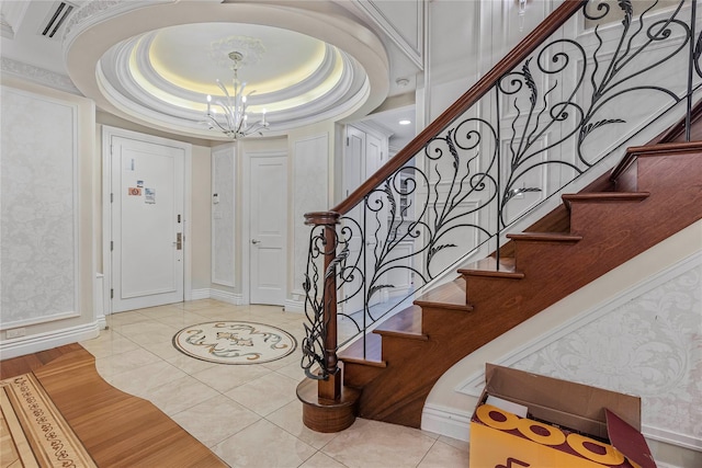 tiled entrance foyer featuring a chandelier