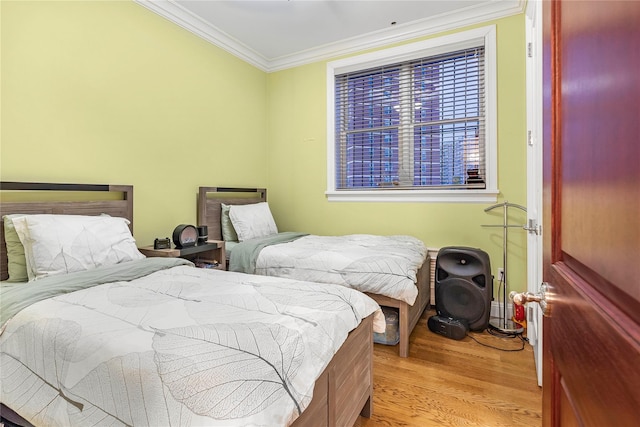 bedroom featuring light hardwood / wood-style floors and ornamental molding