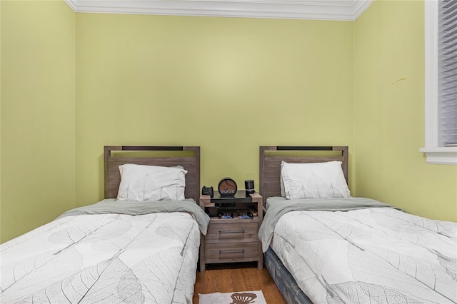 bedroom with crown molding and dark wood-type flooring