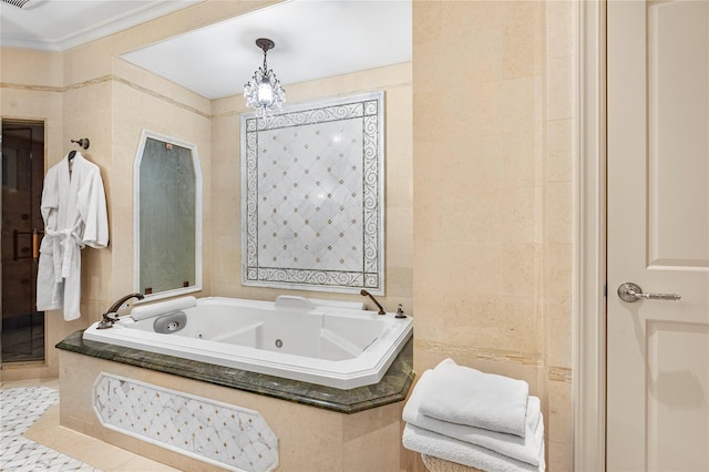 bathroom with tile patterned floors, tiled bath, a chandelier, and tile walls