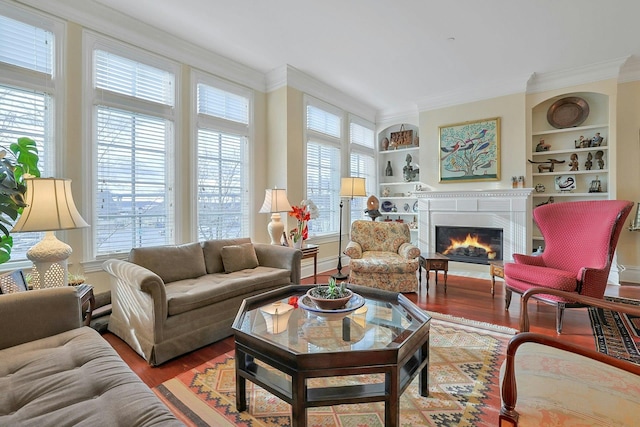 living room featuring built in shelves, wood-type flooring, and ornamental molding