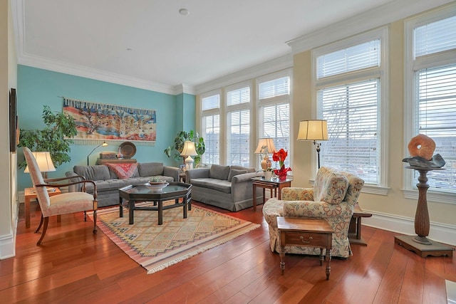 living room with wood-type flooring, a wealth of natural light, and ornamental molding