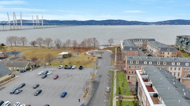 drone / aerial view featuring a water and mountain view