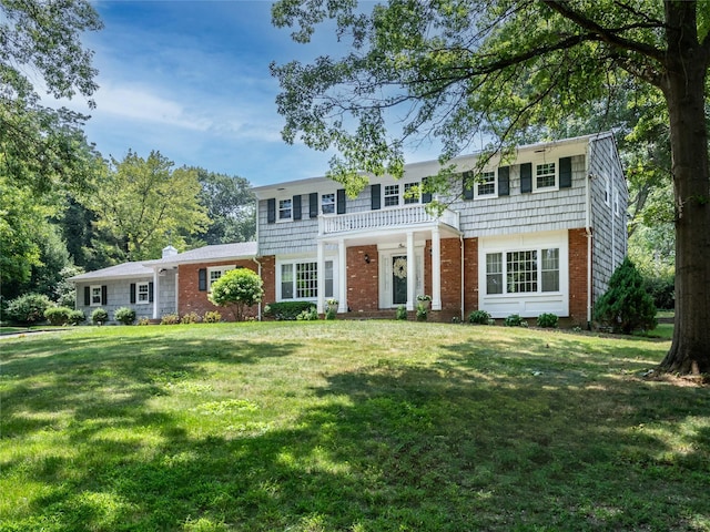 colonial home with a front lawn