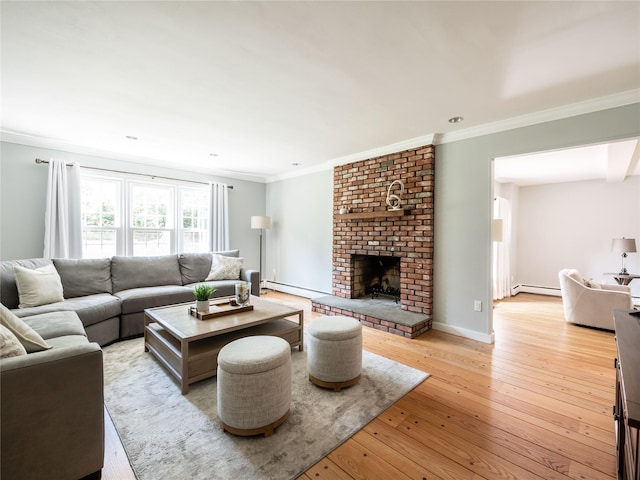 living room featuring light wood-type flooring, a baseboard radiator, a brick fireplace, and crown molding