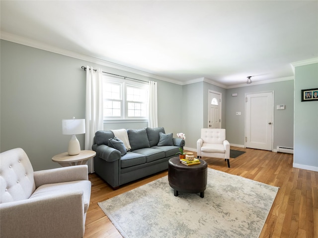 living room featuring light hardwood / wood-style flooring, a baseboard heating unit, and ornamental molding