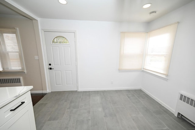 foyer entrance featuring radiator heating unit