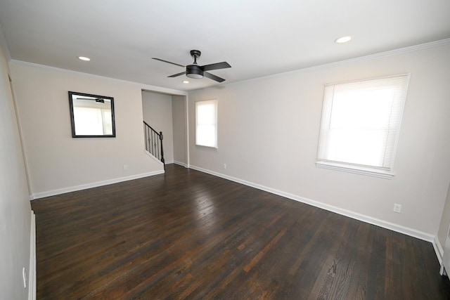 spare room with dark hardwood / wood-style floors, ceiling fan, and crown molding