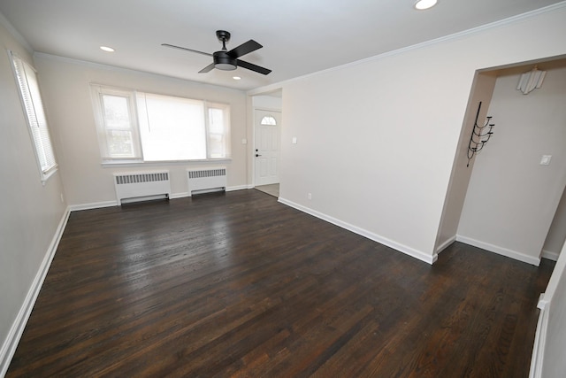 unfurnished living room with dark hardwood / wood-style floors, radiator, and ceiling fan