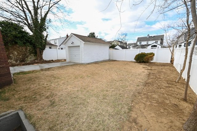 view of yard with a garage and an outdoor structure