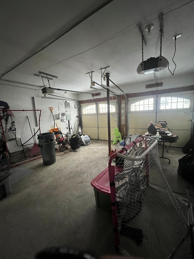 garage with electric panel and a garage door opener