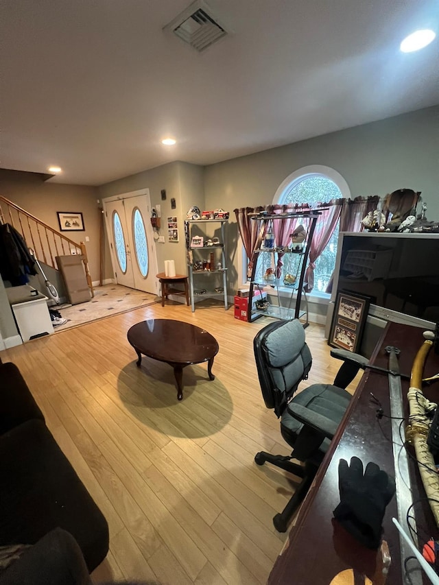 living room with french doors and hardwood / wood-style floors