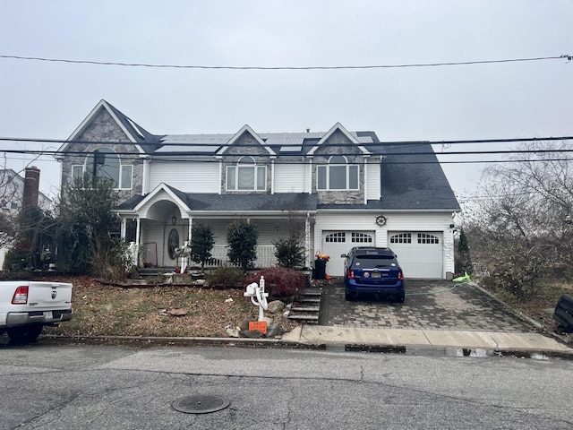 view of front of home with a porch and solar panels