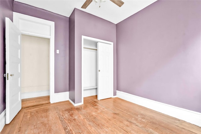 unfurnished bedroom with ceiling fan, a closet, and light hardwood / wood-style floors