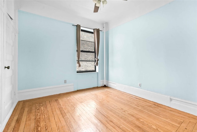 empty room featuring hardwood / wood-style flooring and ceiling fan