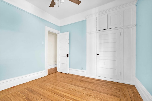 unfurnished bedroom featuring ceiling fan, a closet, and light hardwood / wood-style floors