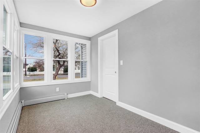 carpeted spare room with baseboard heating