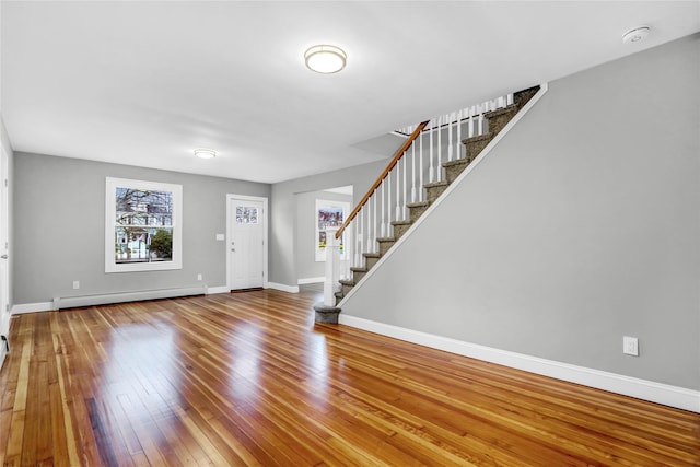 entrance foyer with wood-type flooring and baseboard heating