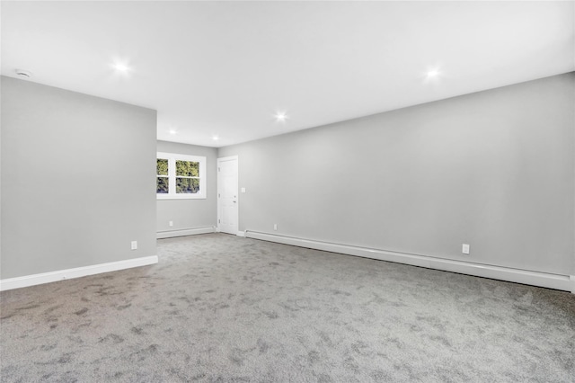 unfurnished room with carpet floors and a baseboard radiator