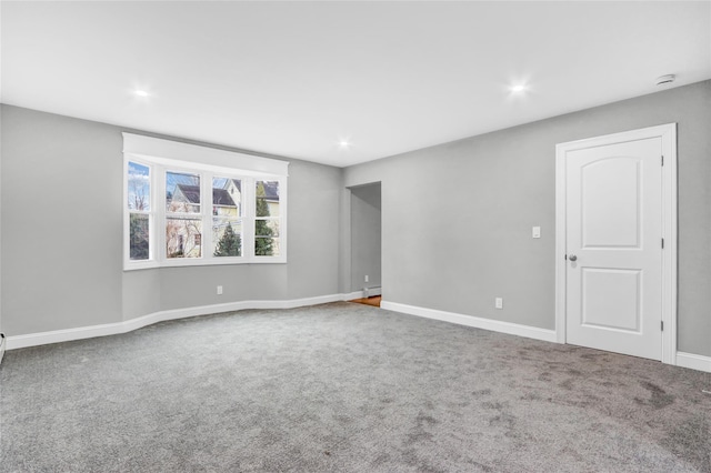 carpeted empty room with baseboard heating