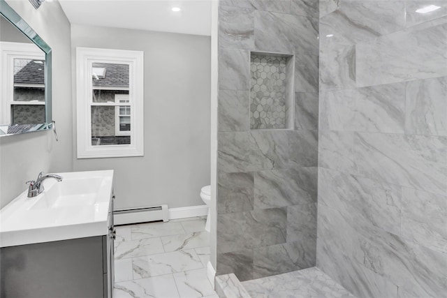 bathroom with baseboard heating, vanity, tiled shower, and toilet