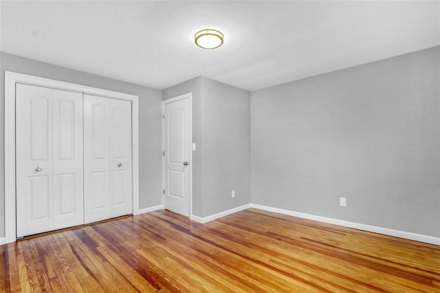 unfurnished bedroom featuring hardwood / wood-style flooring and a closet