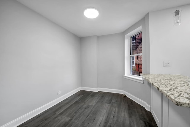 unfurnished room featuring dark hardwood / wood-style floors