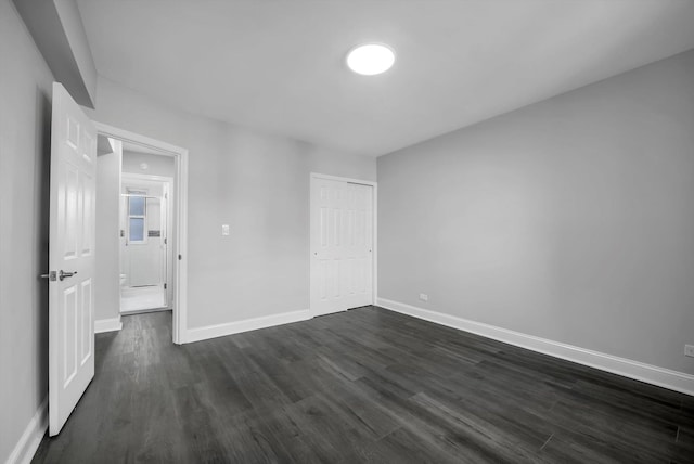 unfurnished room with dark hardwood / wood-style floors