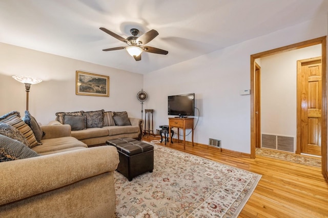 living room with ceiling fan and hardwood / wood-style flooring