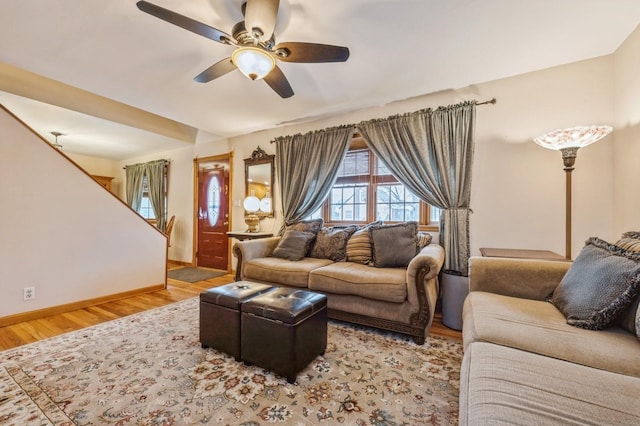 living room featuring ceiling fan and light wood-type flooring