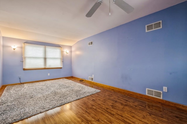 unfurnished room featuring hardwood / wood-style flooring, ceiling fan, and vaulted ceiling