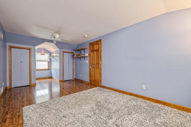 unfurnished bedroom featuring dark hardwood / wood-style flooring, ceiling fan, and lofted ceiling