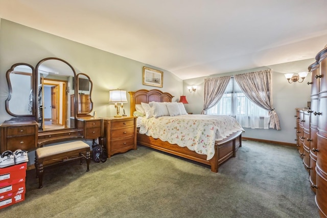 bedroom featuring lofted ceiling and dark colored carpet