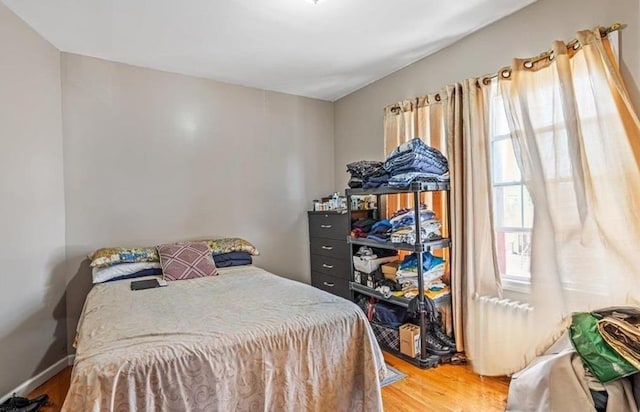 bedroom with hardwood / wood-style floors