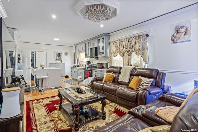 living room featuring light hardwood / wood-style floors and ornamental molding