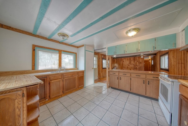 kitchen with white range with electric stovetop, sink, and light tile patterned floors