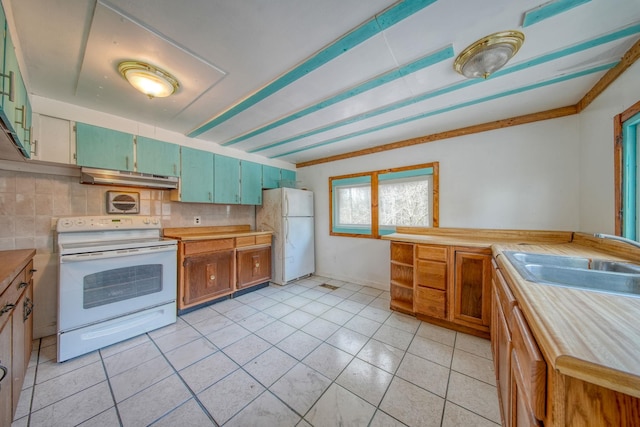 kitchen with tasteful backsplash, white appliances, sink, butcher block countertops, and green cabinets