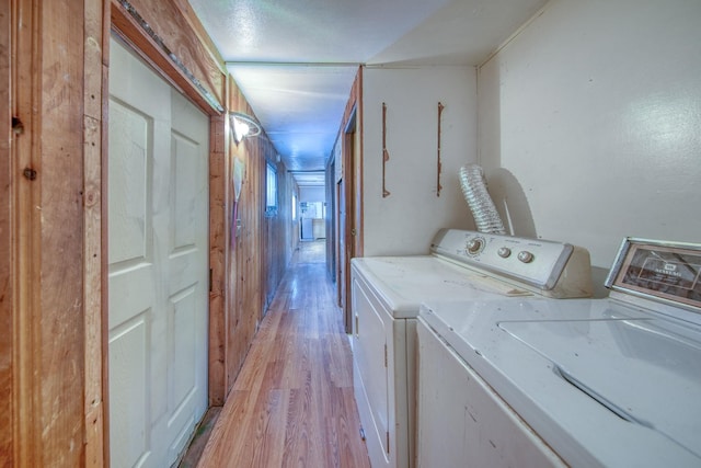 washroom featuring separate washer and dryer and light hardwood / wood-style flooring