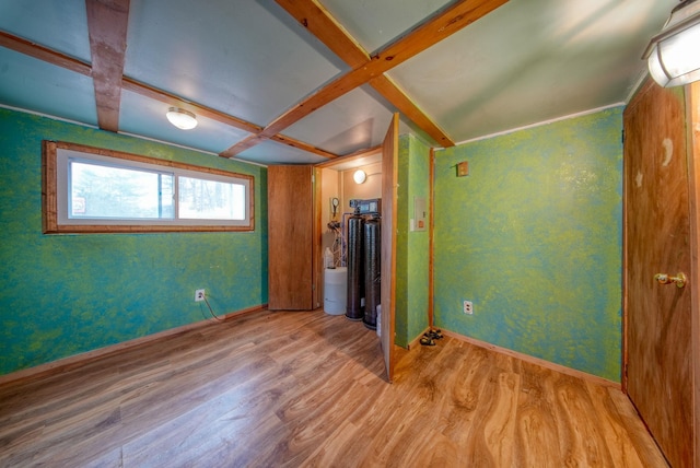 unfurnished bedroom with light wood-type flooring and coffered ceiling