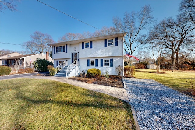 raised ranch with a front lawn