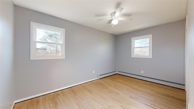 empty room with a baseboard radiator, ceiling fan, and light hardwood / wood-style floors