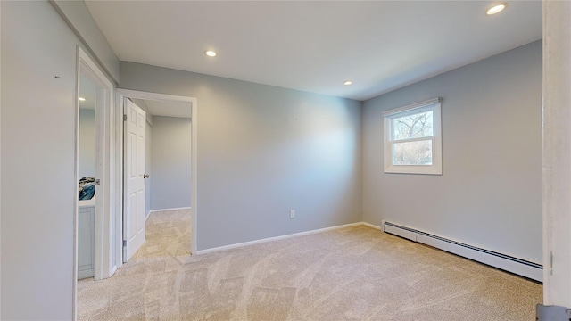 carpeted empty room featuring a baseboard radiator